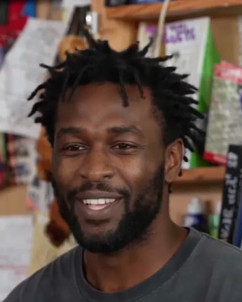 Seat 1, Lead singer: a face from a Tiny Desk AI sample video