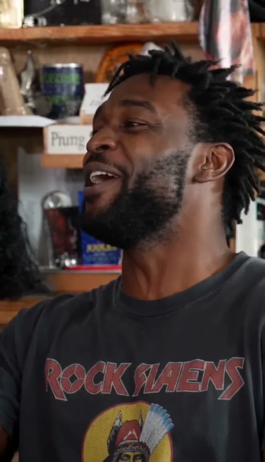 The lead singer laughing in the long close-up of a Tiny Desk AI sample video
